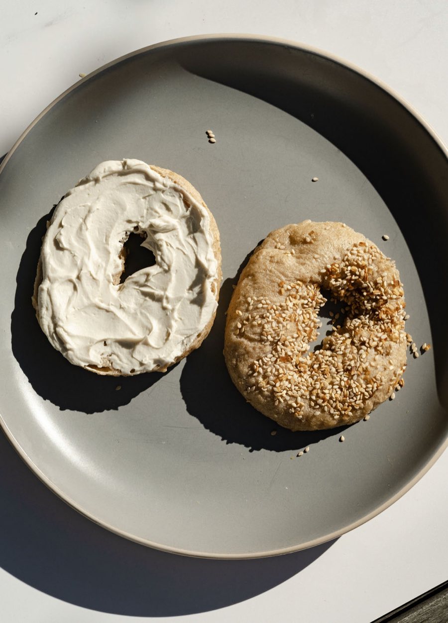 A bagel with a thick swirl of Monty's cream cheese