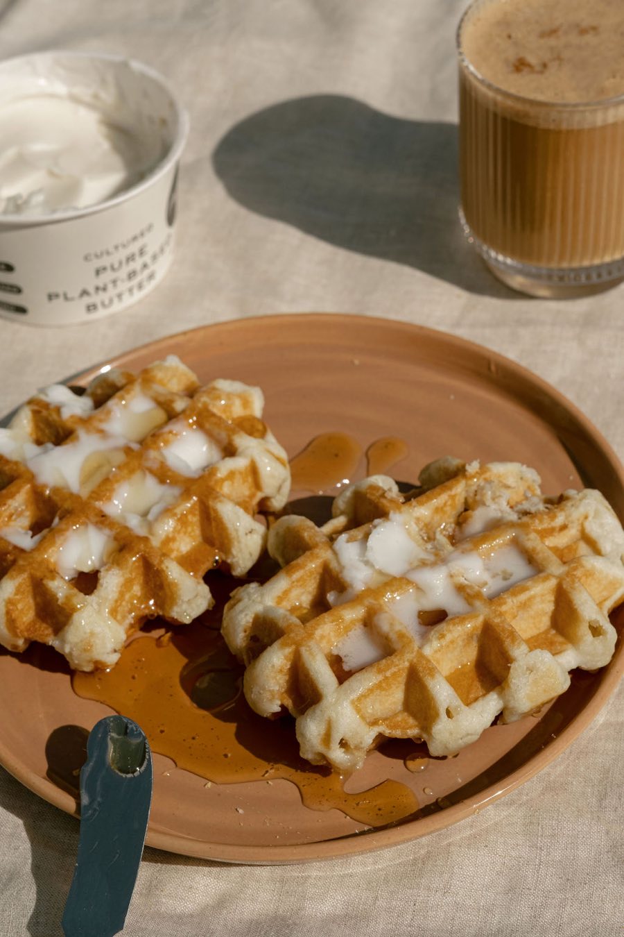 Golden waffles topped with melting Monty's Oat Butter
